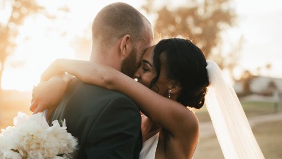 A couple hugging after their wedding