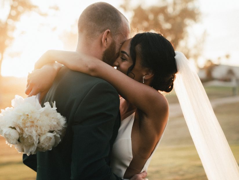 A couple hugging after their wedding