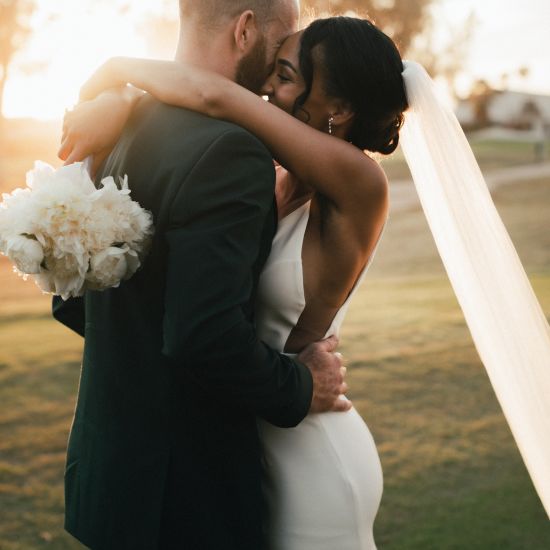 A couple hugging after their wedding