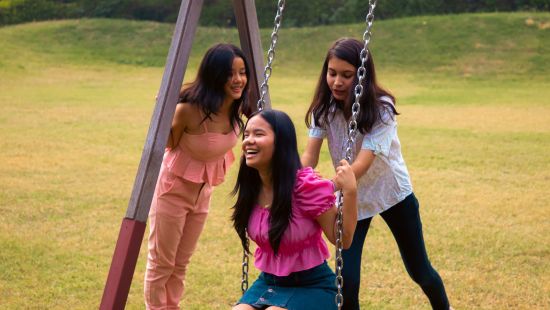 kids playing on a swing in playground