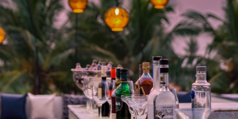 Liquor bottles placed in a line at a bar counter at our Benaulim Beach resort