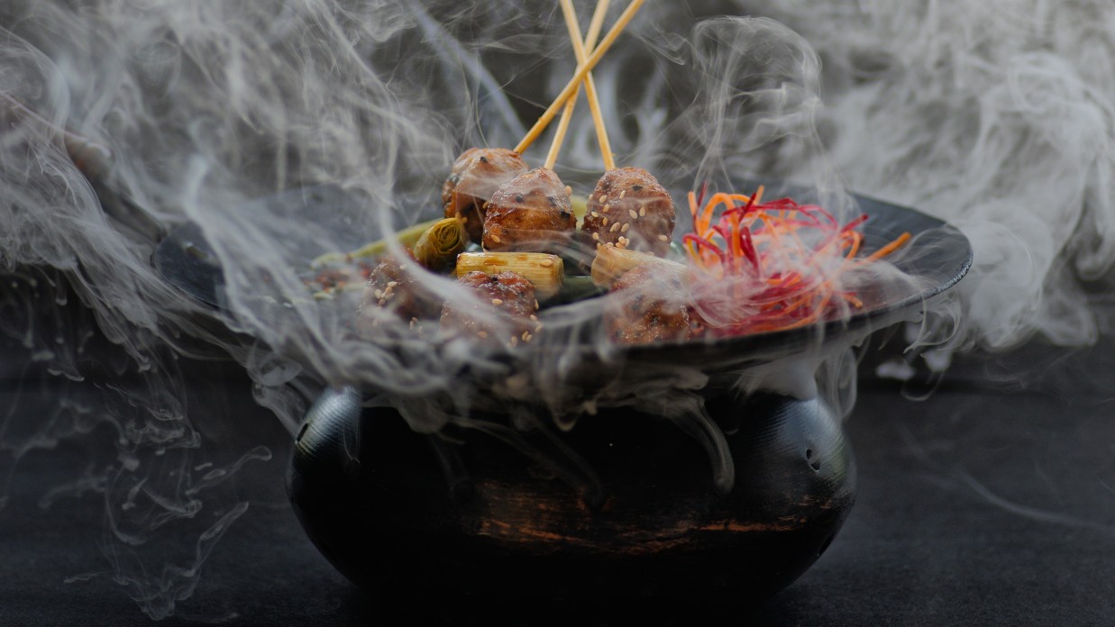 Smoke wafting off a black bbq sizzler pot at one of our Benaulim beach restaurants in South Goa