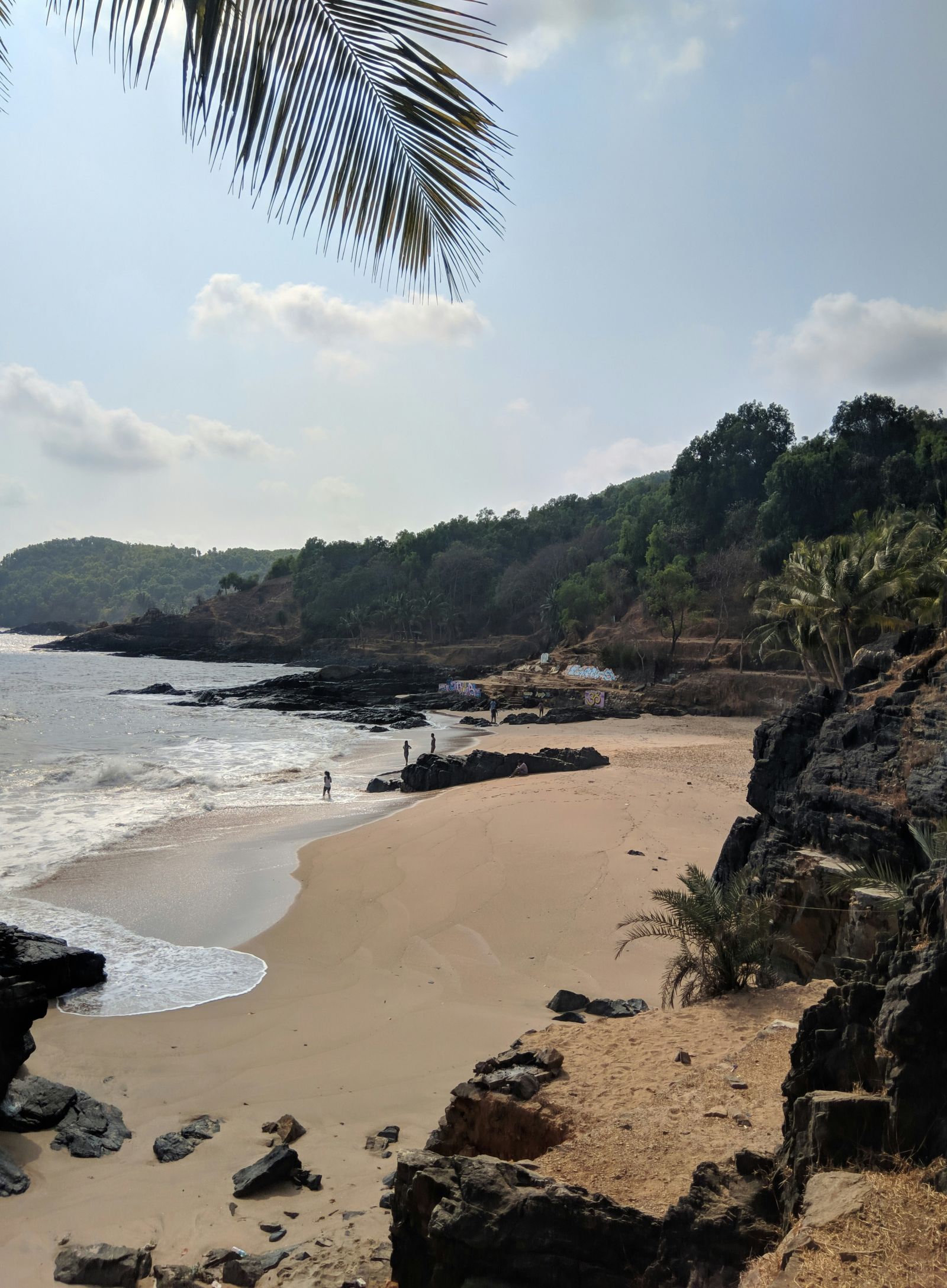 a far out view of a beach in Gokarna with water overlapping on the beach
