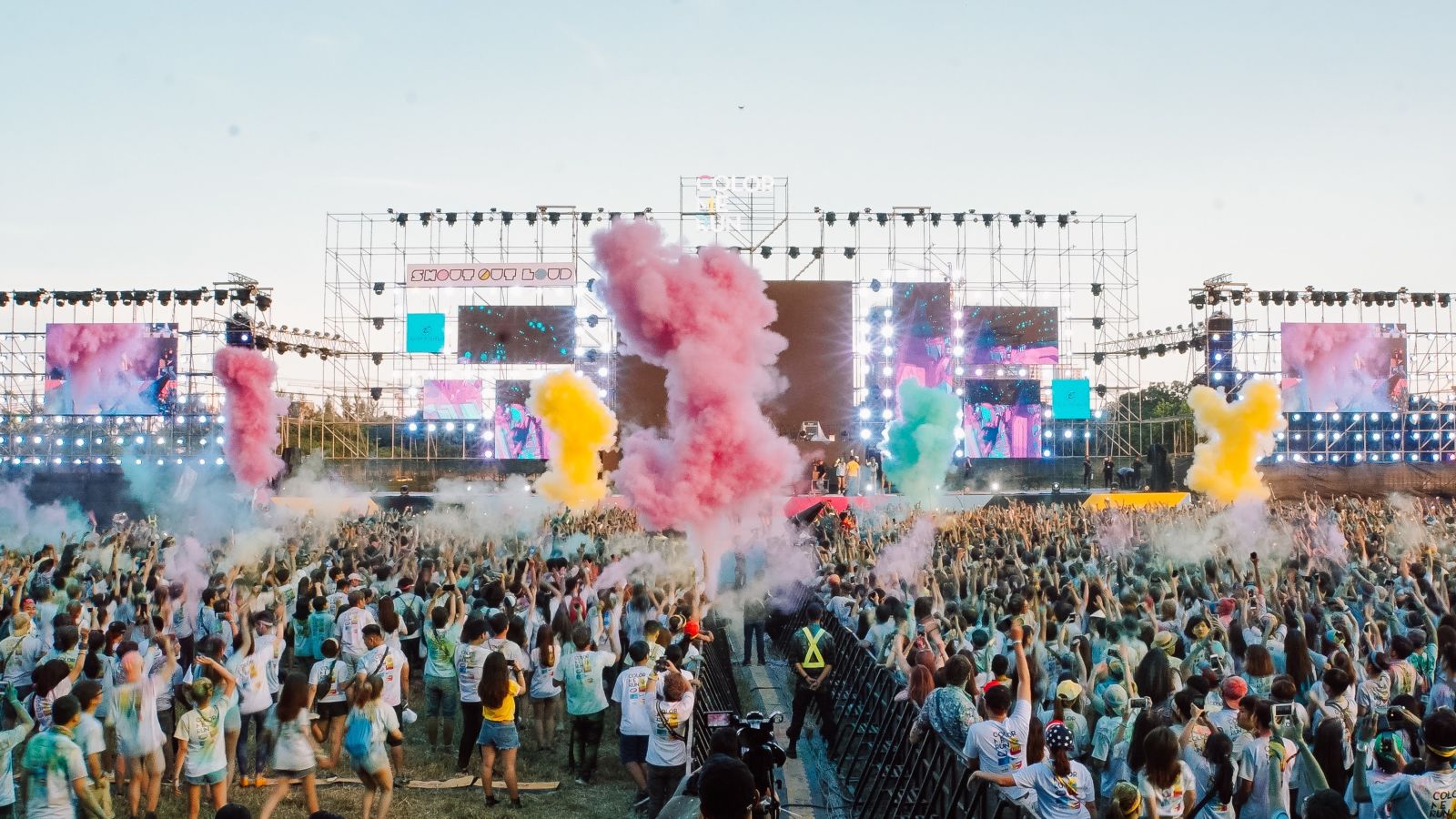 an image of a concert with people playing with colours