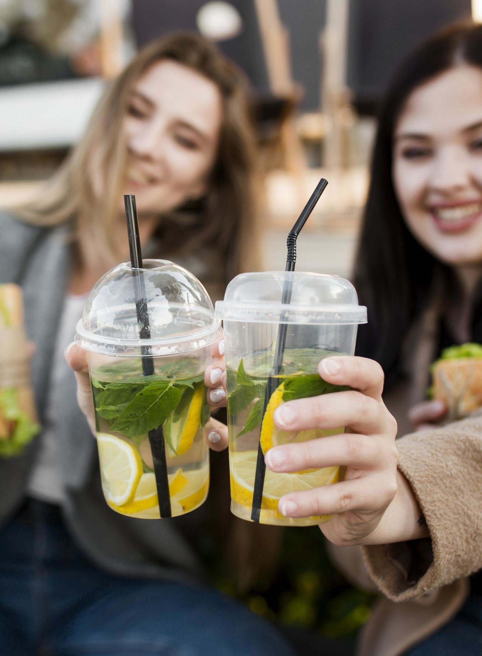 two people holding drinks and smiling