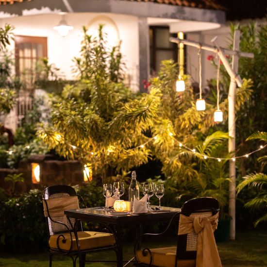 a romantic dinner setup with lights and candles