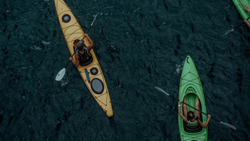 People sitting inside a kayak doing Kayaking