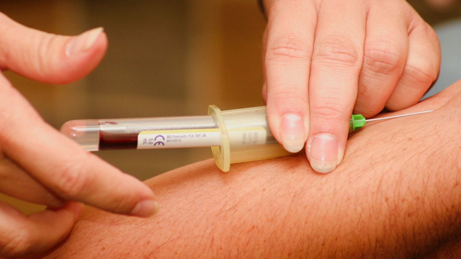 a person taking a blood sample