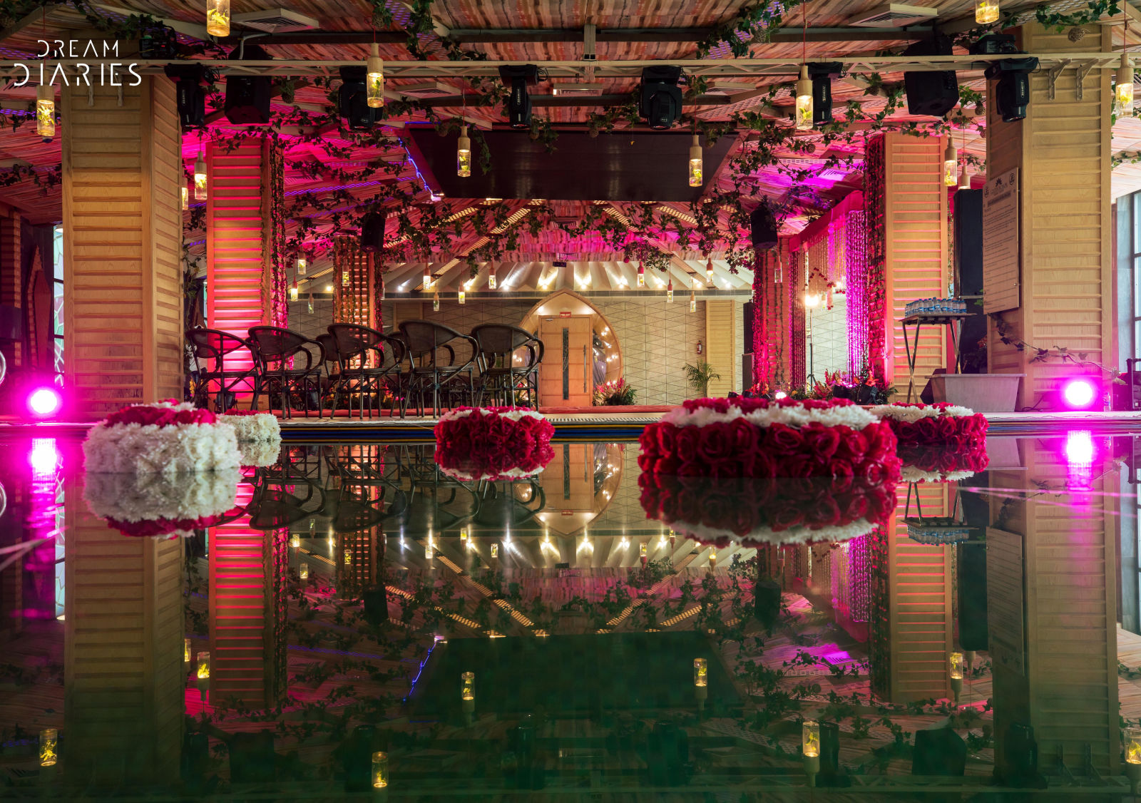 A well decorated banquet hall with seating arrangements and a dance floor - Golden Blossom Imperial resorts Lucknow