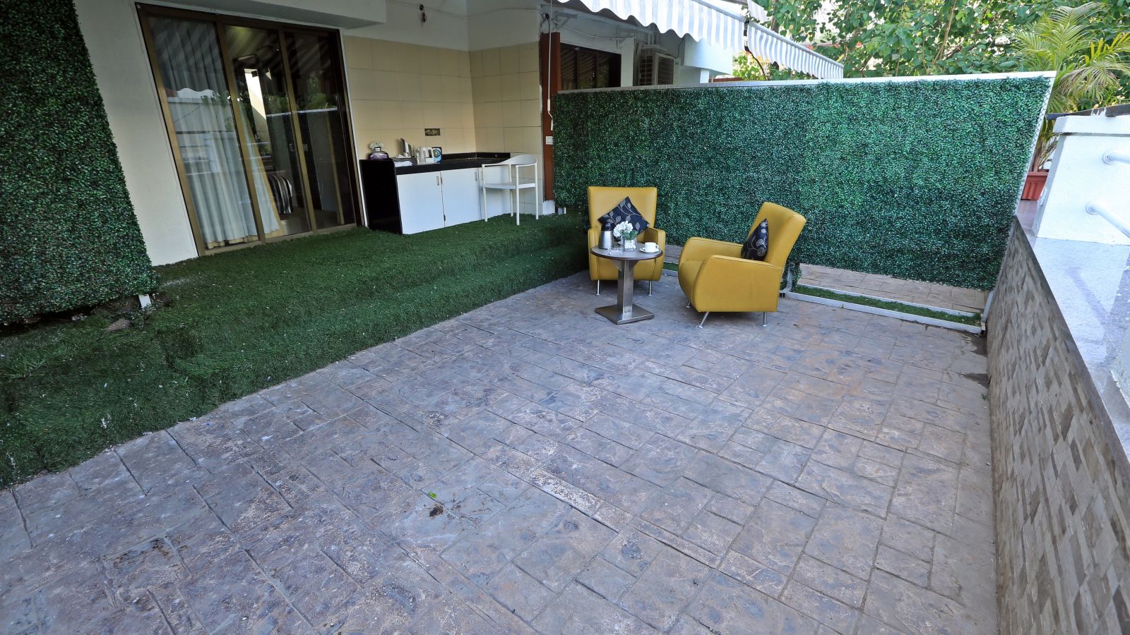 Image of the terrace area with seating area at Premuim Garden Room at The Oriental Residency