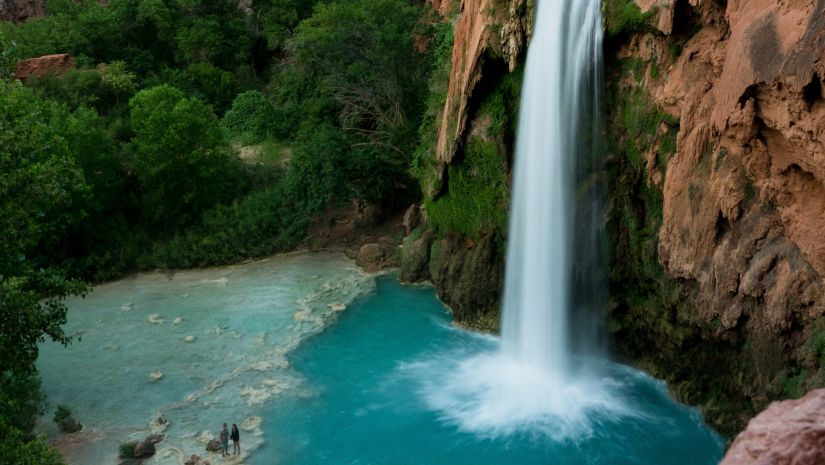 A waterfall among large mountains