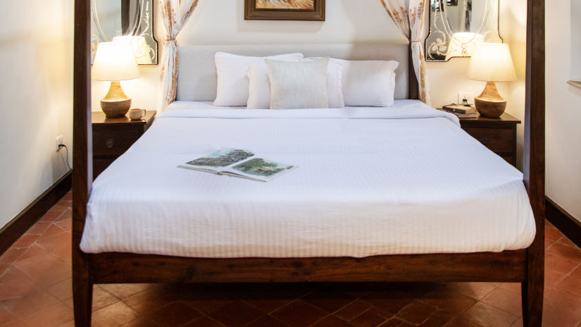 white room with white bed and bedsheets @ Lamrin Ucassaim Hotel, Goa