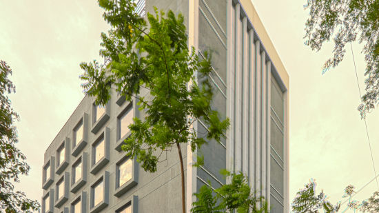 Facade image of Nexstar Suites in pune with trees next to it