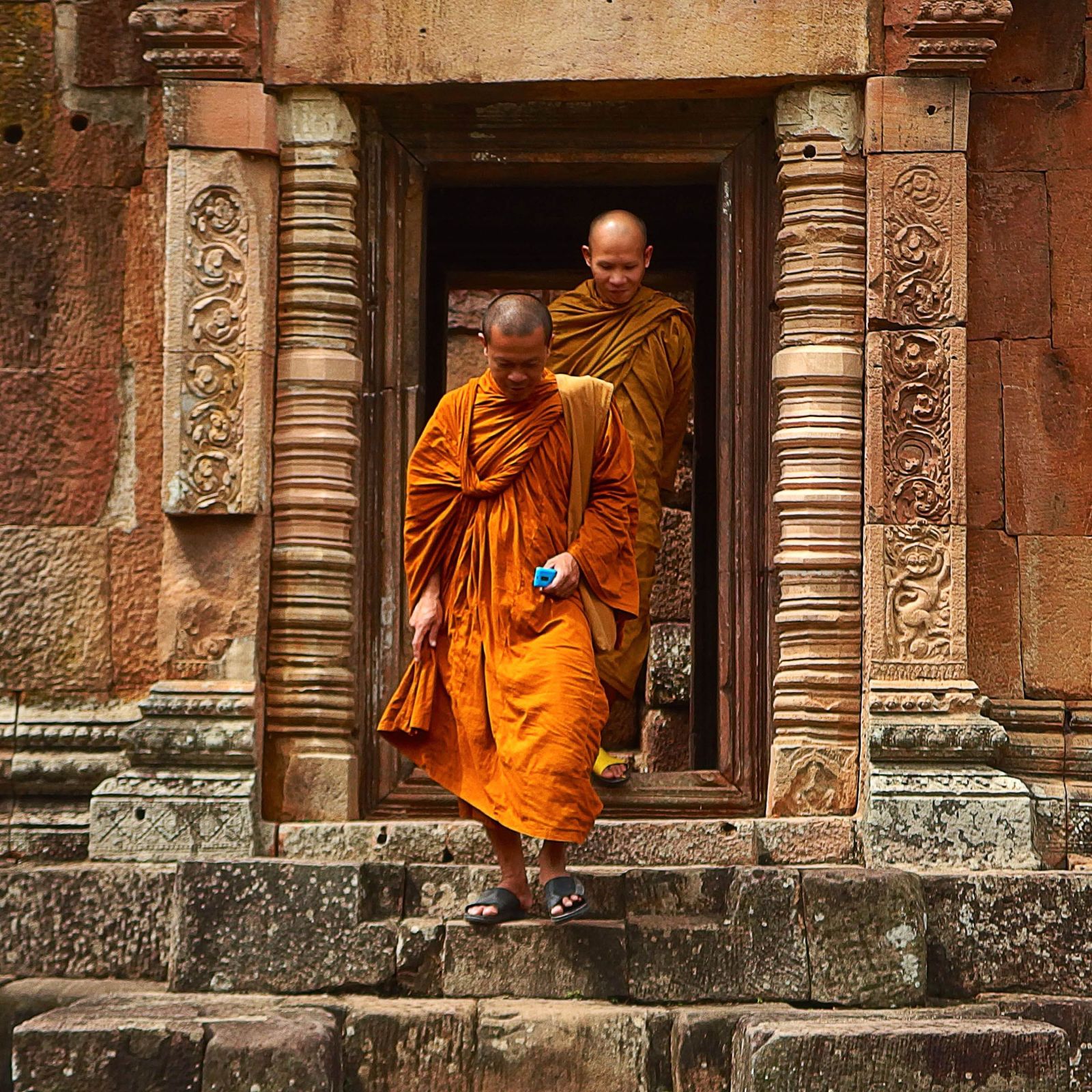 Two monks exiting a monastery