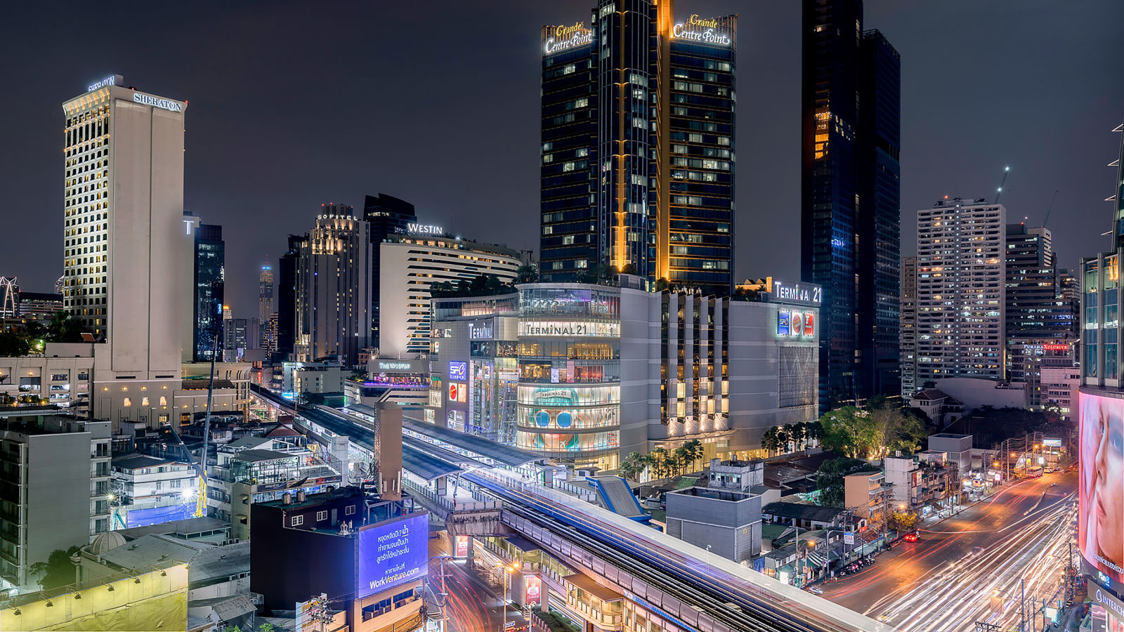 a wide angled view of Asok Montri Road at night - Night Hotel Bangkok