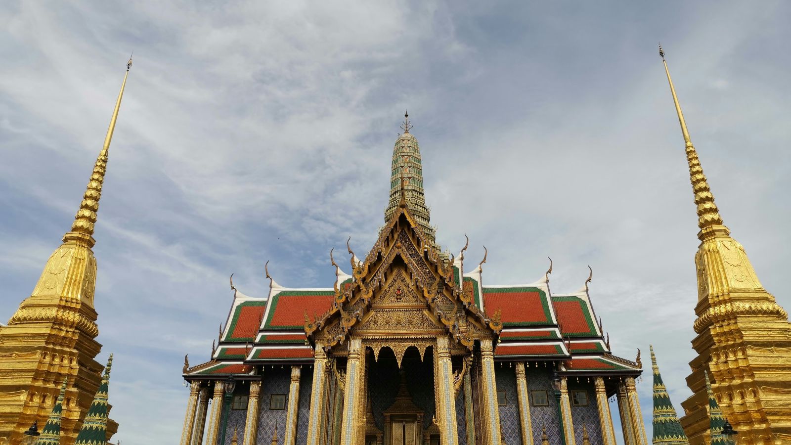 An overview of wat phra kaew with people standing at the entrance for a picture