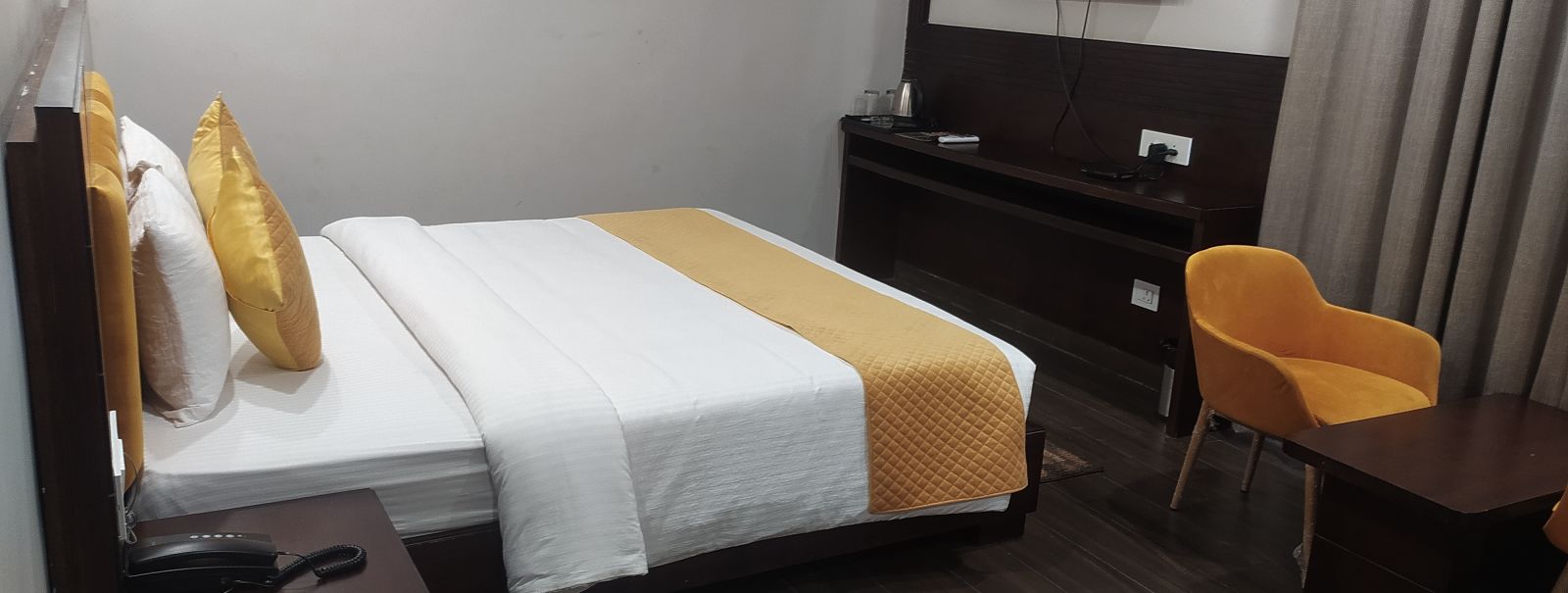 Image of a doubled bed in Tangerine room at Fressotel Shanti Heritage, Haridwar