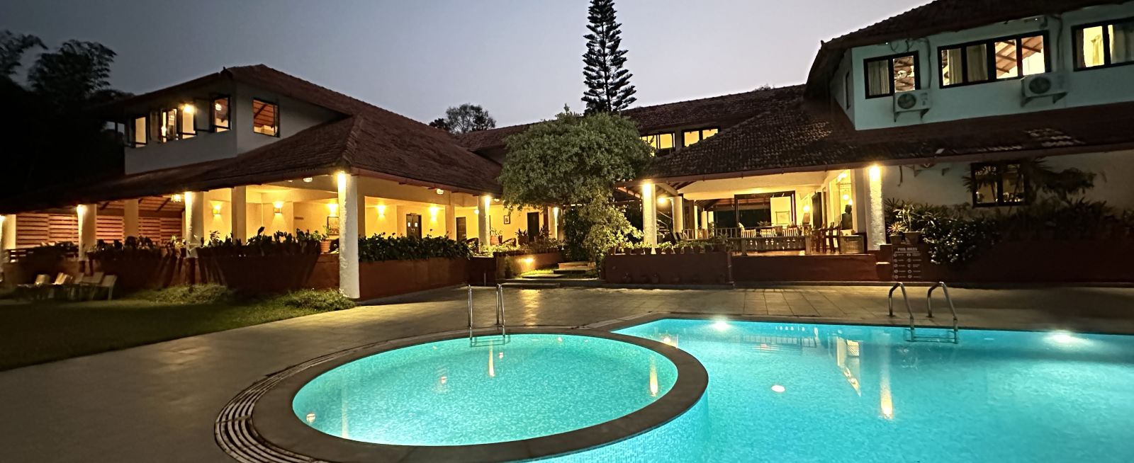 view of a swimming pool with the property in the background - Kadkani River Resort, Coorg