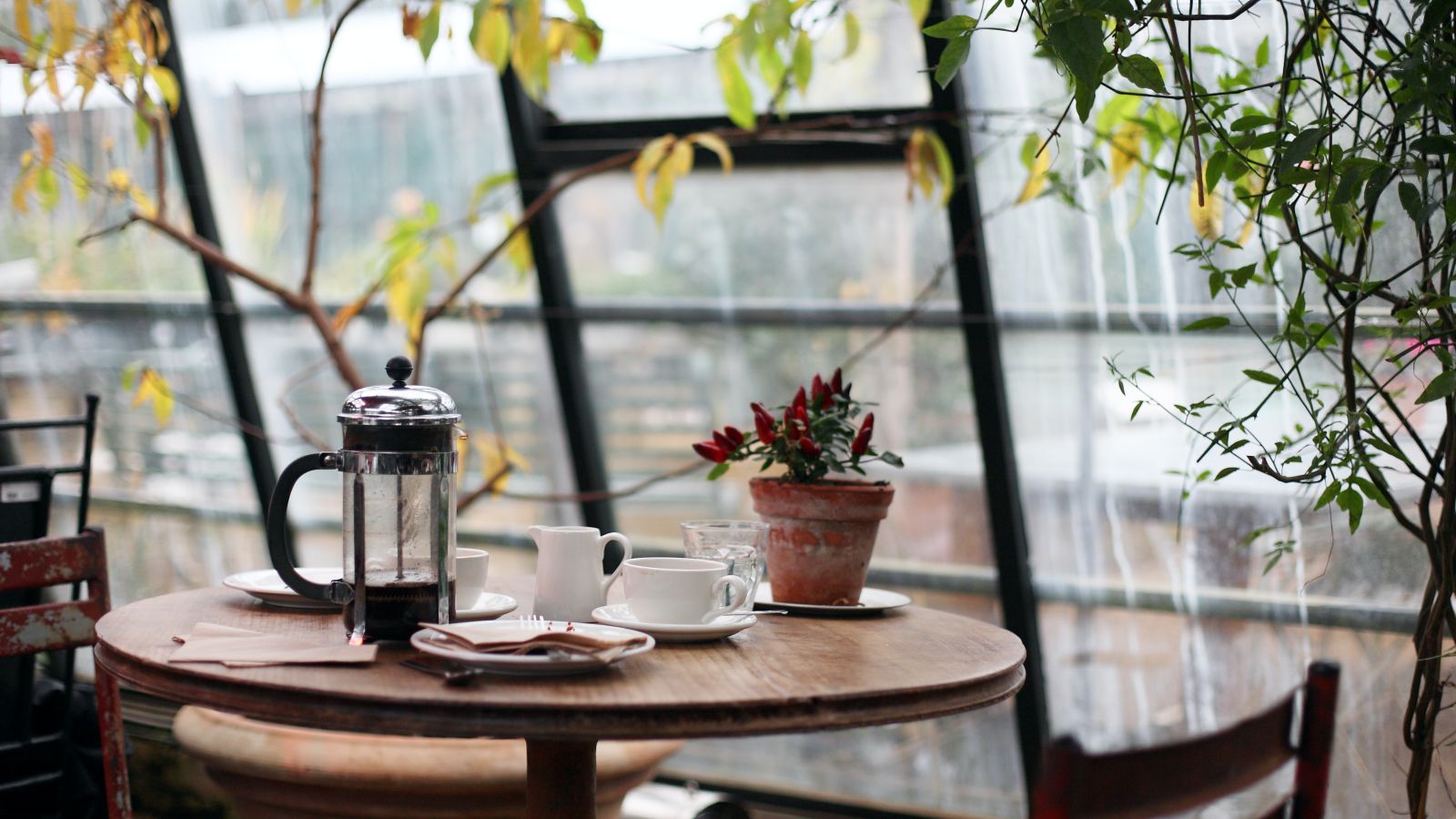 The dining table near large windows at a cafe