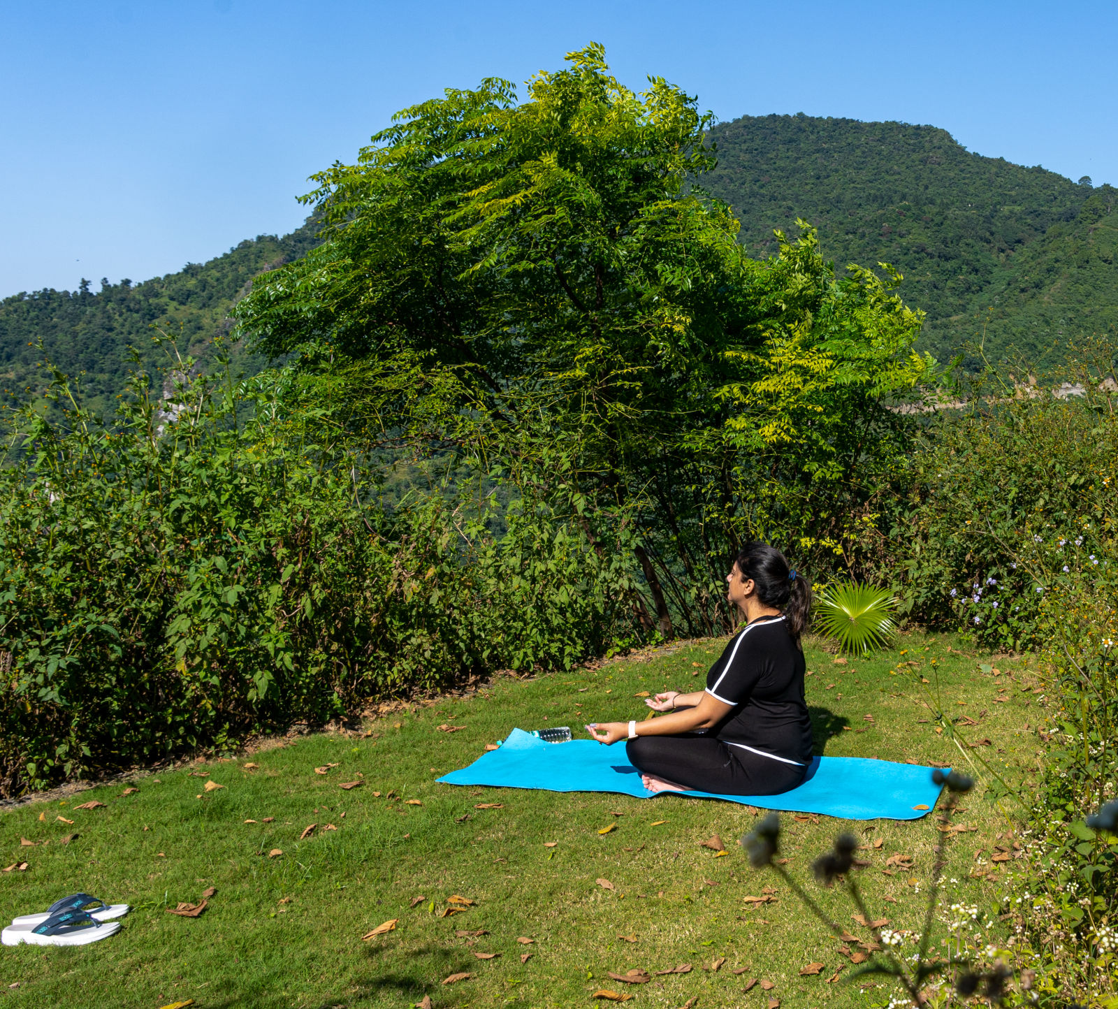 a woman meditating in the grass - Kothli Hills, Rishikesh