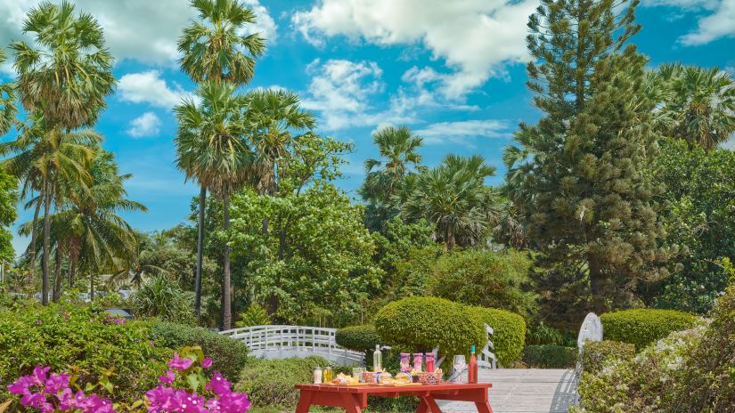 A place surrounded by greenery and flowers with picturesque sky in the background  | The Resort