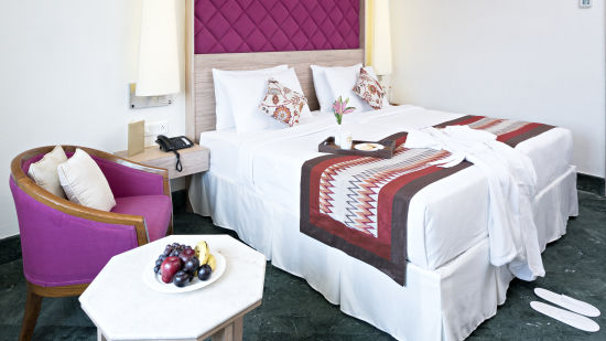 The pink-white interiors of our twin bed superior rooms in Jaipur at Hotel Clarks Amer 