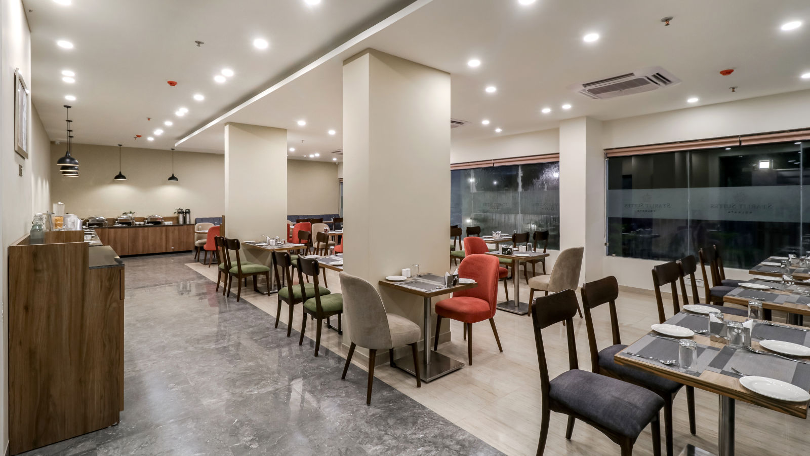 Seating arrangement with buffet counter in view inside Restaurant - Starlit Suites Newtown, Kolkata