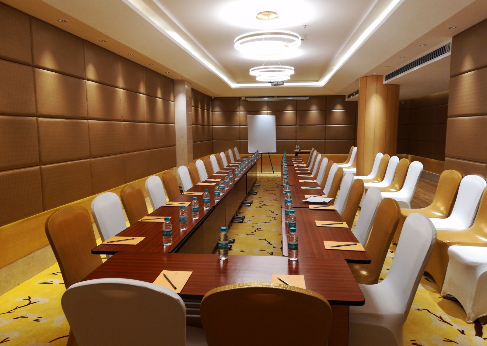 a meeting hall with a long rectangular table with chairs surrounding it - Hotel Fountain Tree By TGI - JP Nagar, Bangalore