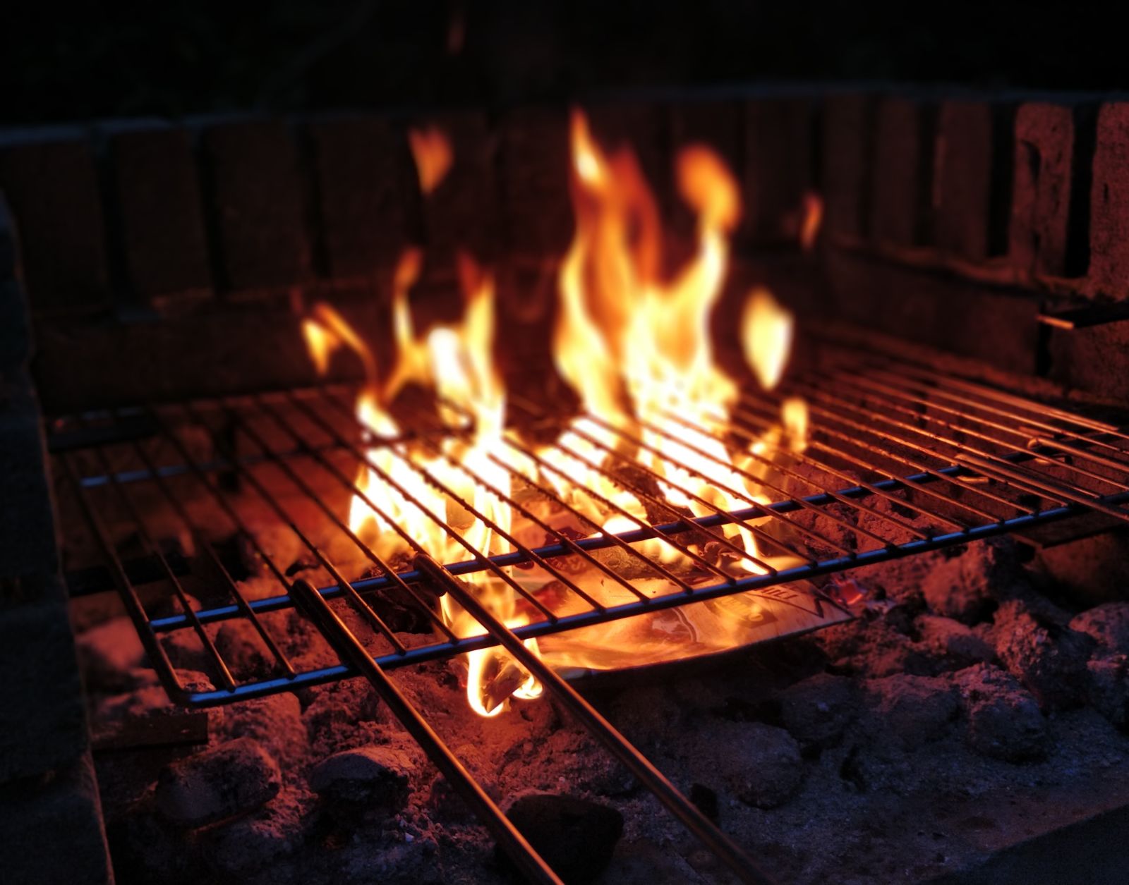 a grill placed over a barbecue pit