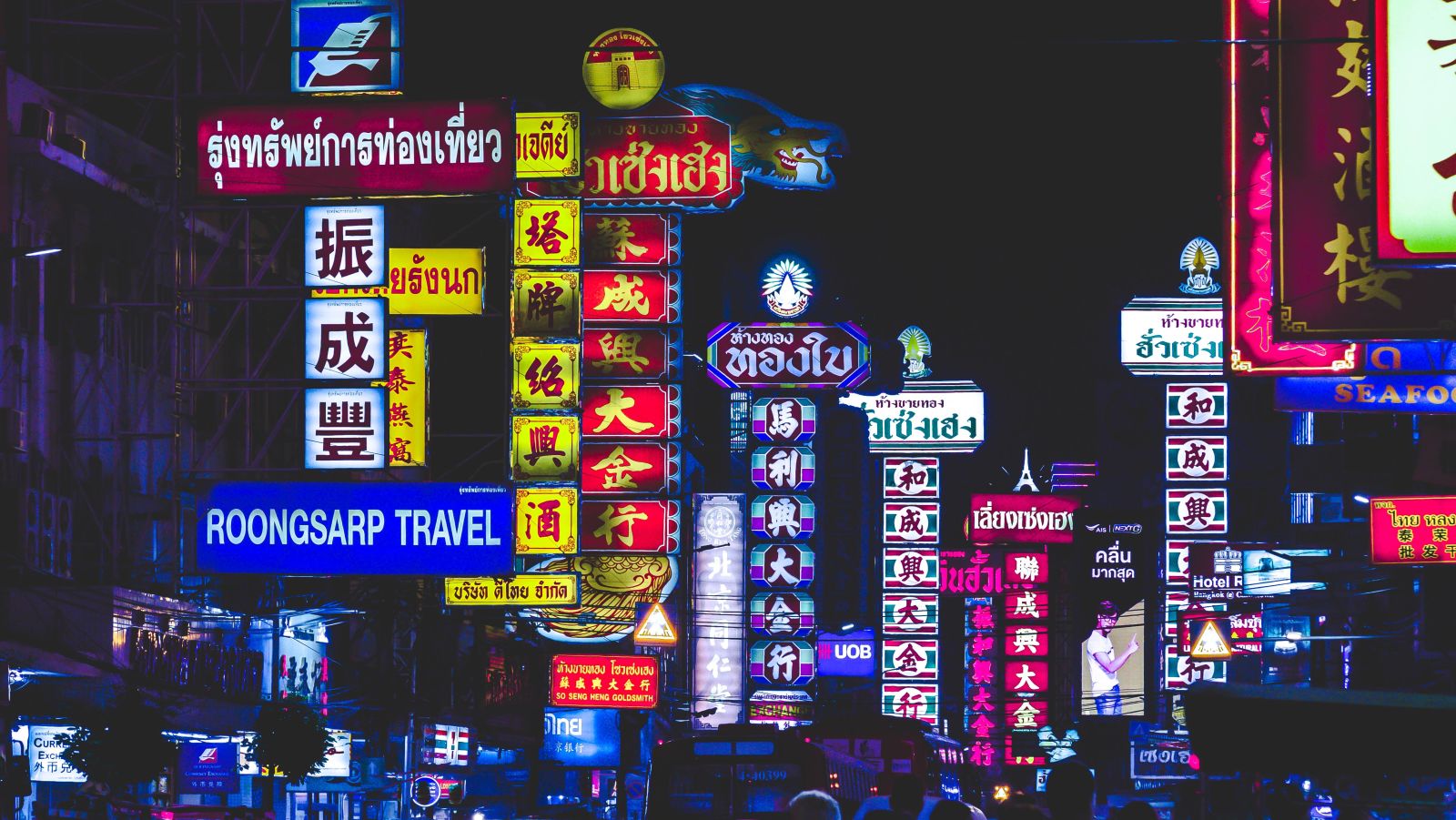 various sign boards on the side of the road in Bangkok