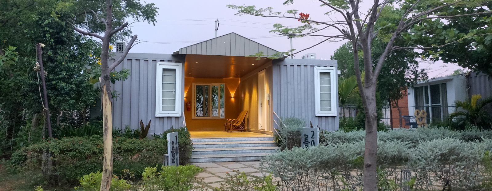 A facade image of the Kalpa cottage with greenery around - Trance Veechika Resort