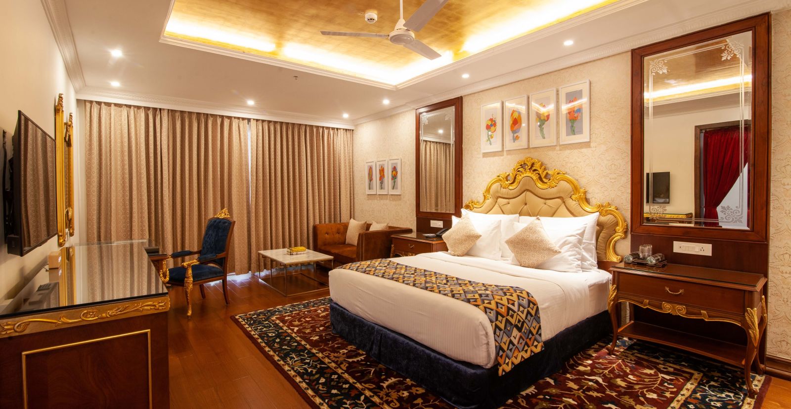 a king size bed facing the TV at one of the rooms - Mayfair Lake Resort, Raipur 