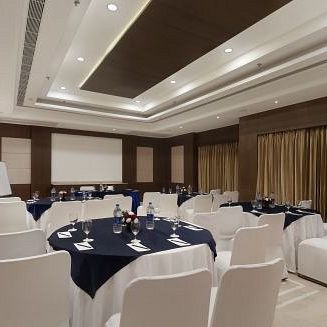 The Senate Banquet Hall with round tables and seating arranged aesthetically for the event at Inde Signature Tower, Gurgaon