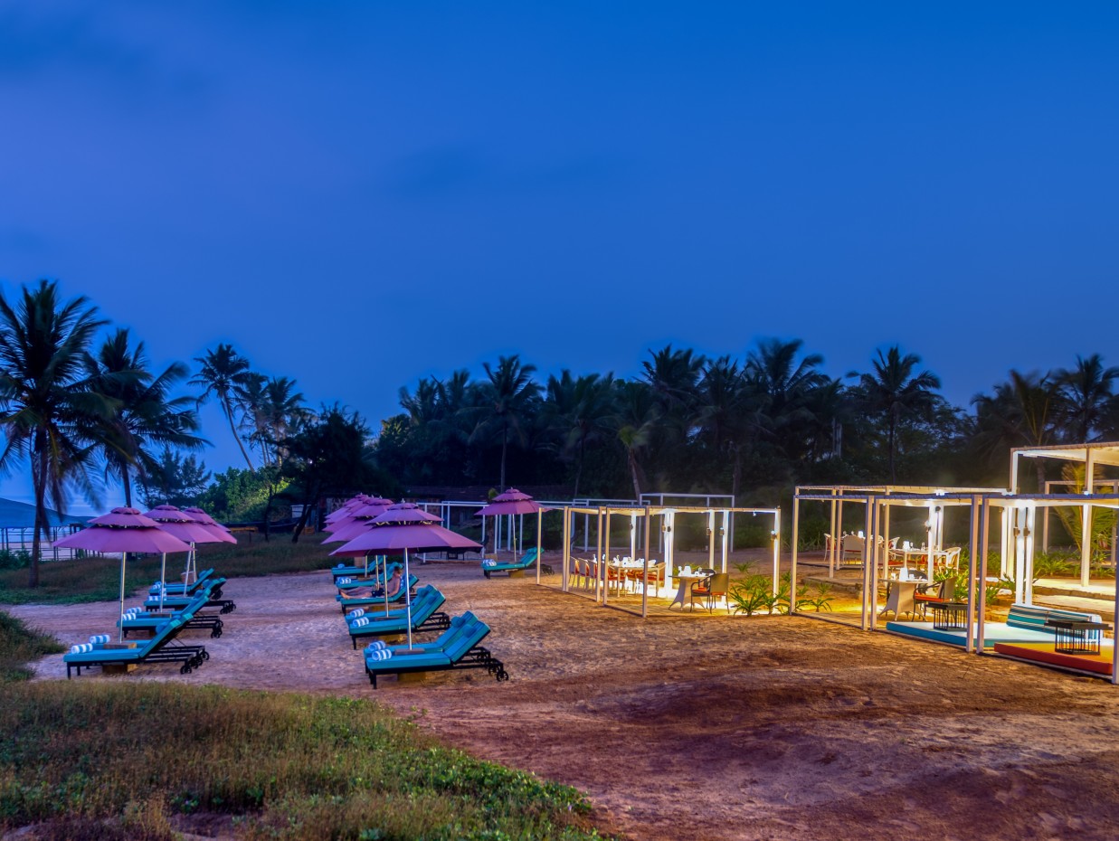 Benaulim beach after sunset with lounge chairs and cabana set up - Azaya Beach Resort Goa