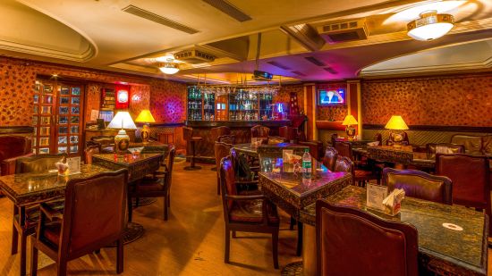 the seating area with the bar counter in the background at the Bar at Raj Park Hotel in Alwarpet, Chennai