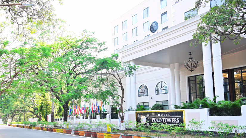 Facade view of the entrance to Hotel Polo Towers, Agartala with trees in the foreground