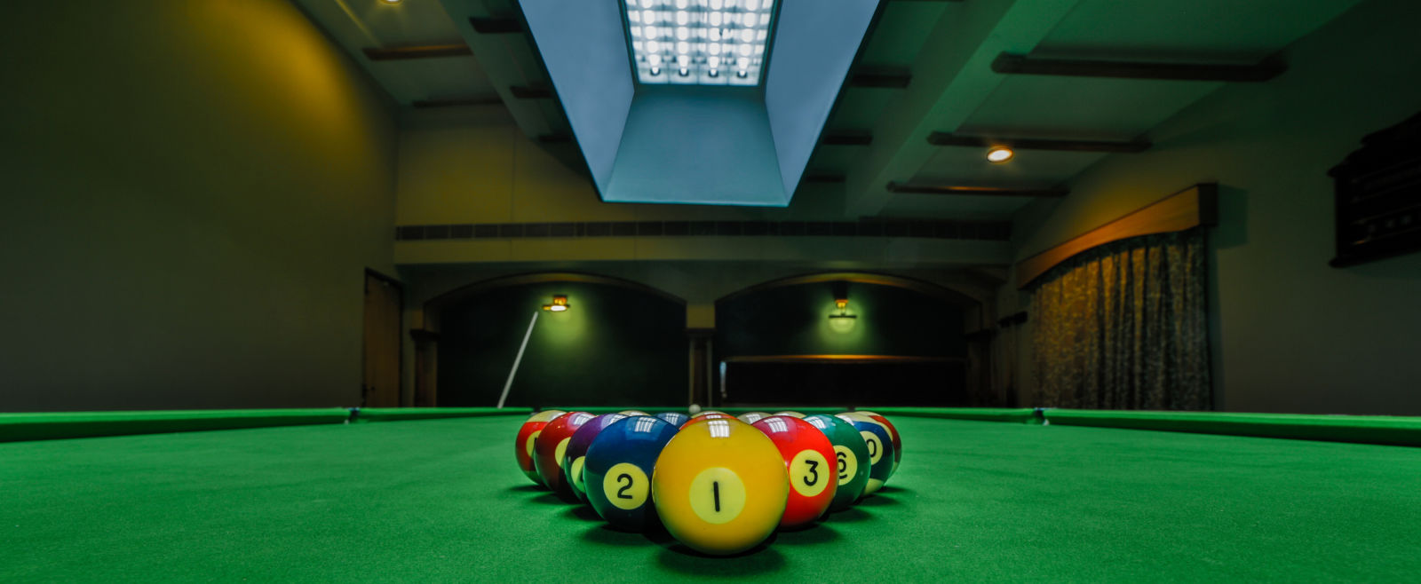 pool table with billiards ball placed on the table at Hotel Tara, Hyderabad