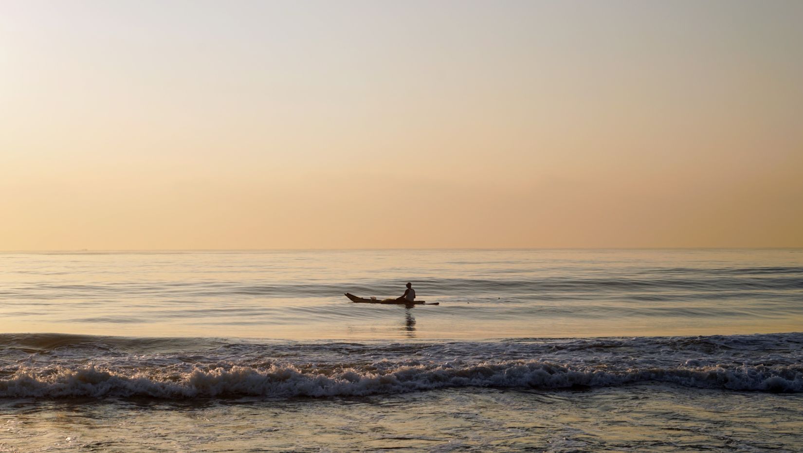 Lotus Eco beach resort, one person on a boat in the sea