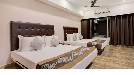 Deluxe Family room with two large beds with alrge windows opening into the balcony - Yashshree Milestone, Siliguri