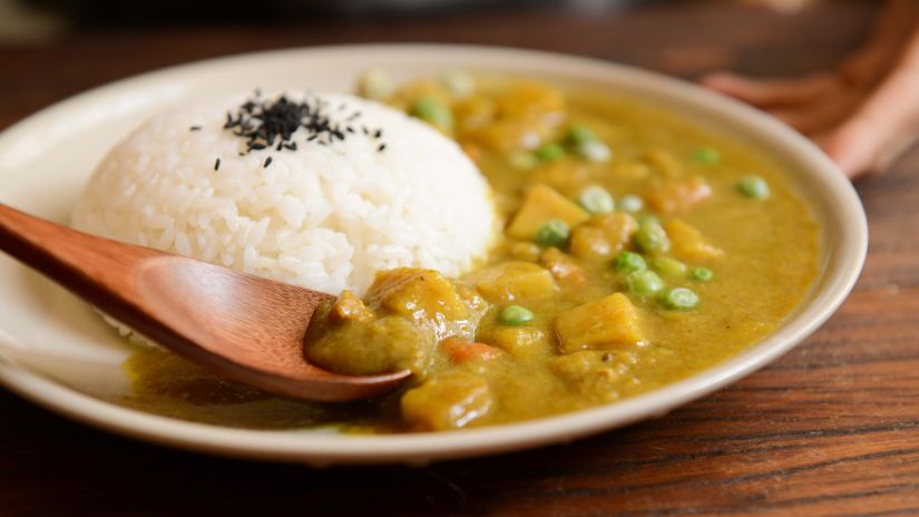 A traditional dish with cumin seeds sprinkled over rice and gravy of beans and potatoes