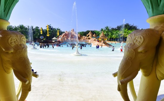 alt-text Water Kingdom - wide angle view of a pool with people in in during daytime