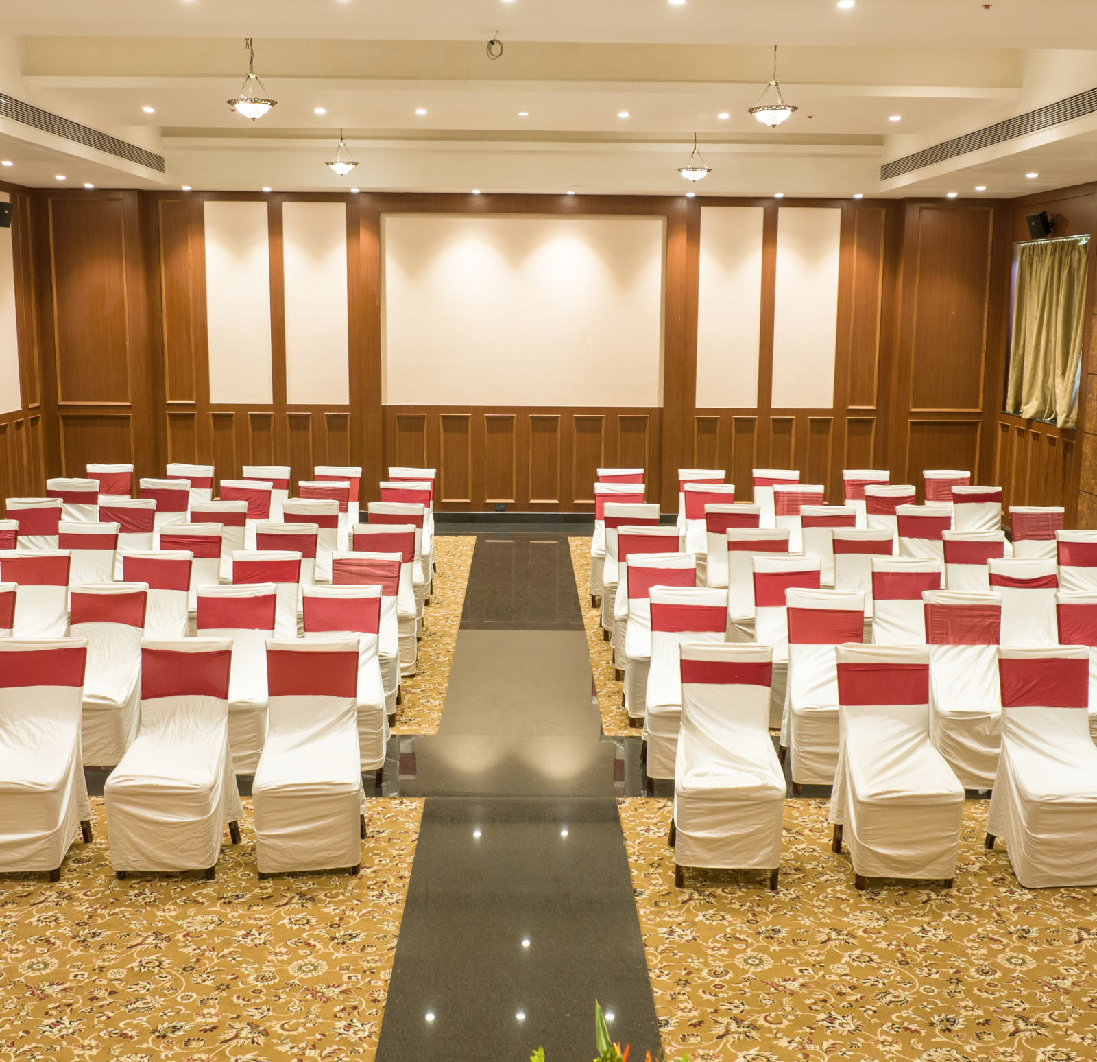 Conference/ Banquet room with neatly palced chairs  at Ocean Spray Puducherry