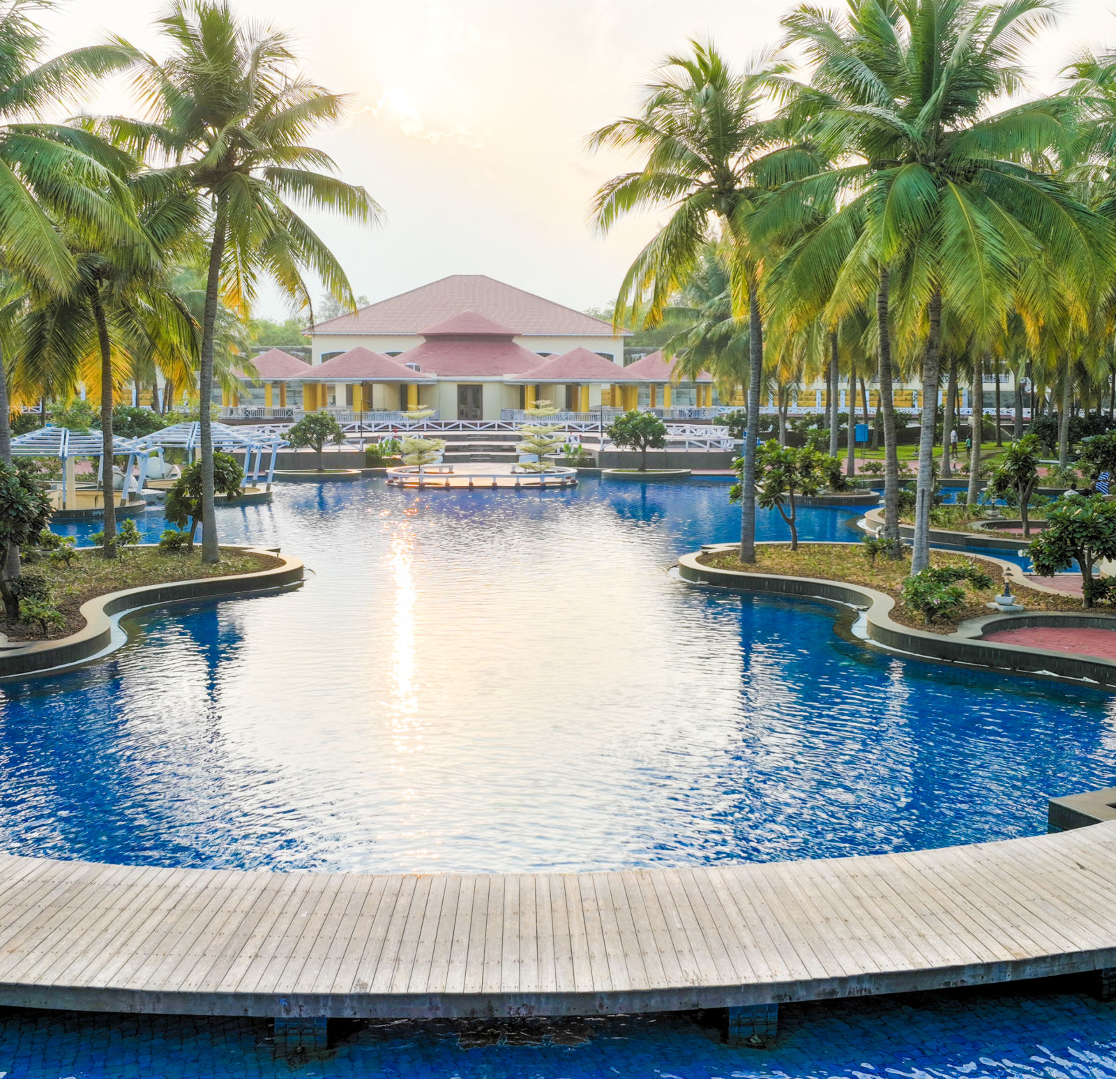 1Swimming pool surrounded by coconut trees at Ocean Spray, Pondicherry