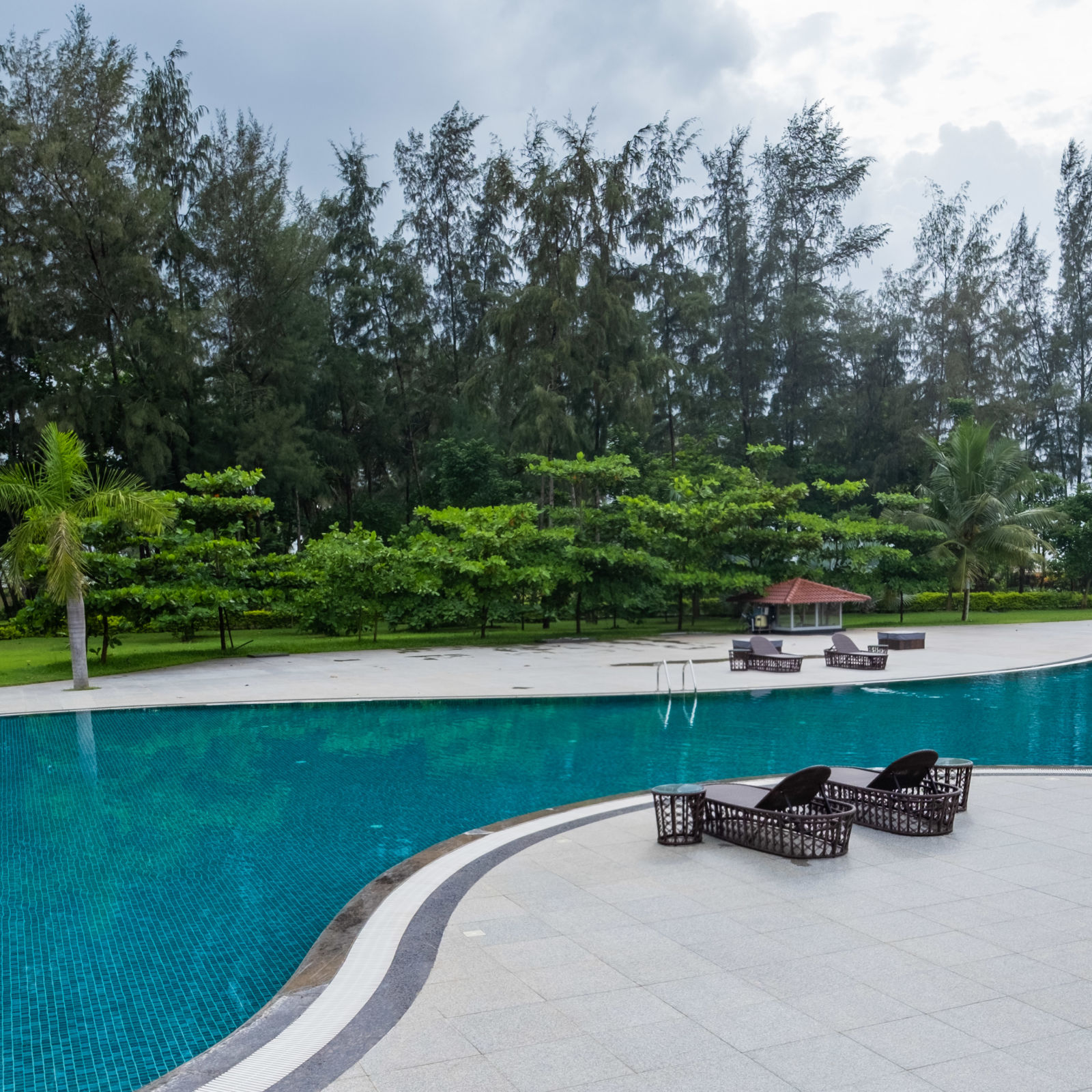 view of sunlougers beside the pool at gamyam retreat