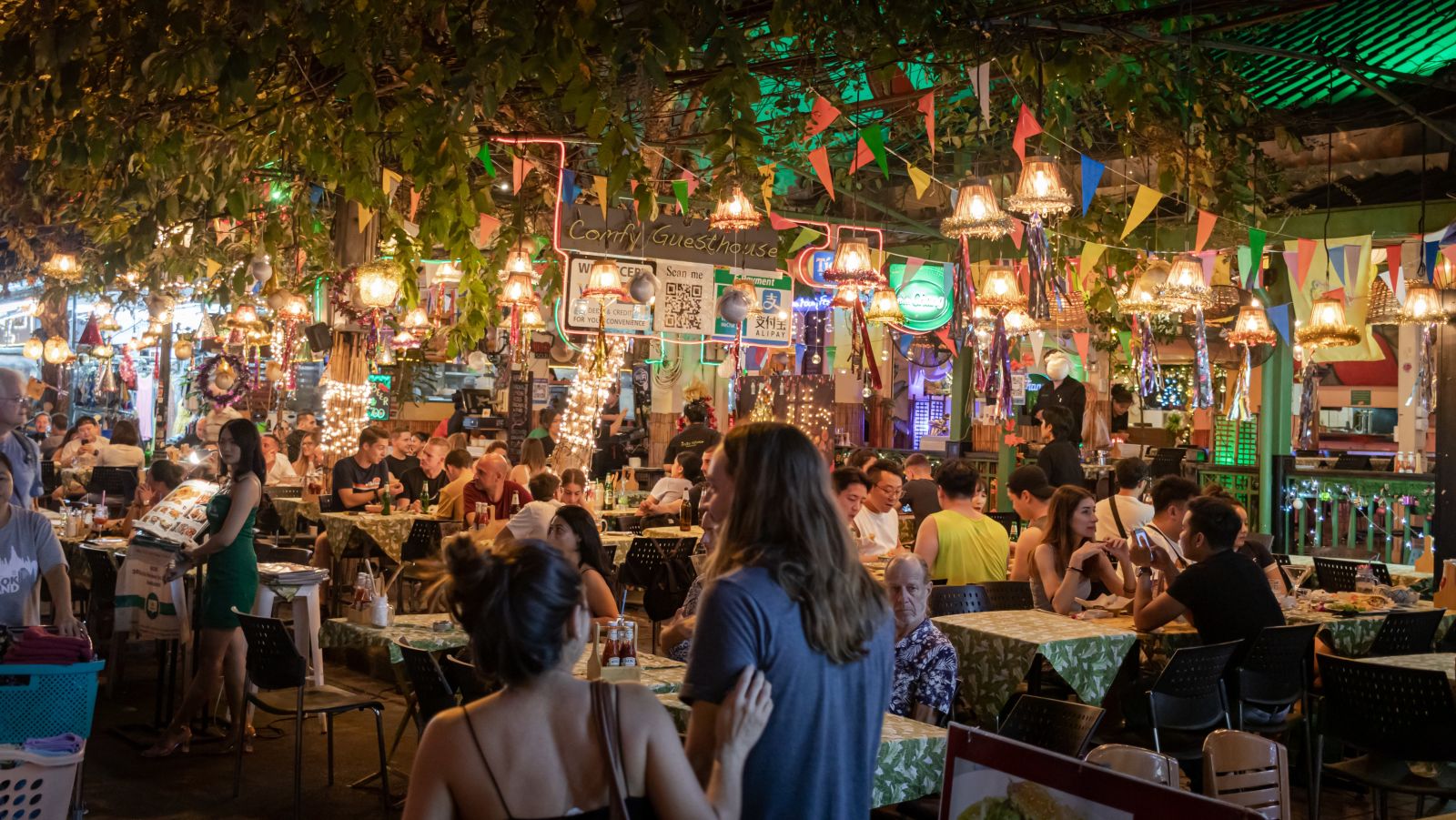people enjoying food at a night restaurant in Bangkok