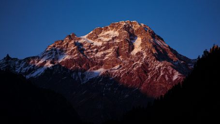 a view from Great Himalayan National Park, Himachal Pradesh of the peak covered with snow - great himalayan national park unesco