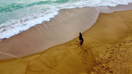 a person standing on the beach at our resort in south goa - Caravela Beach Resort Goa