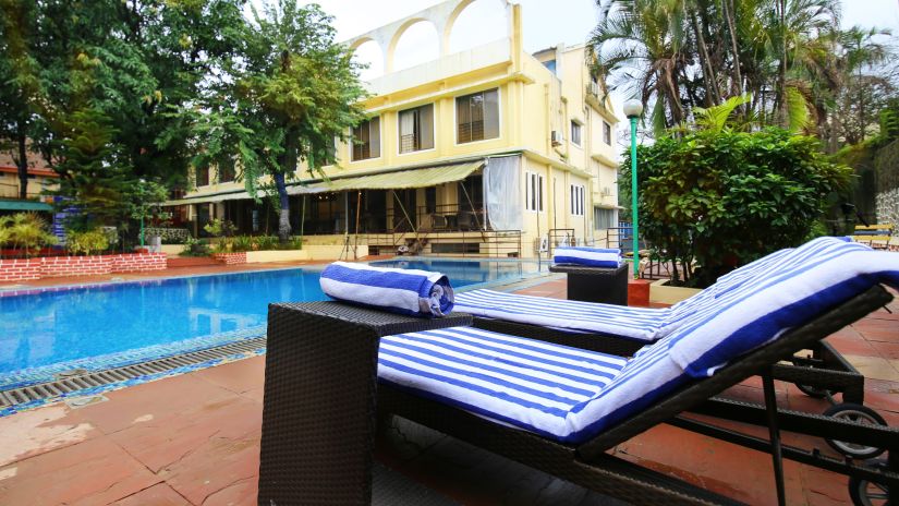 the sun-bathing beds kept by the pool at our resort - Zara's Resort