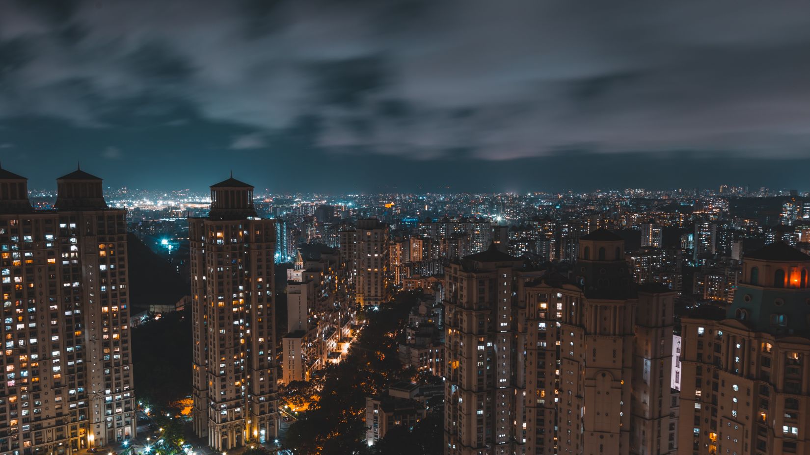 towering skyscrapers with well-lit windows at night