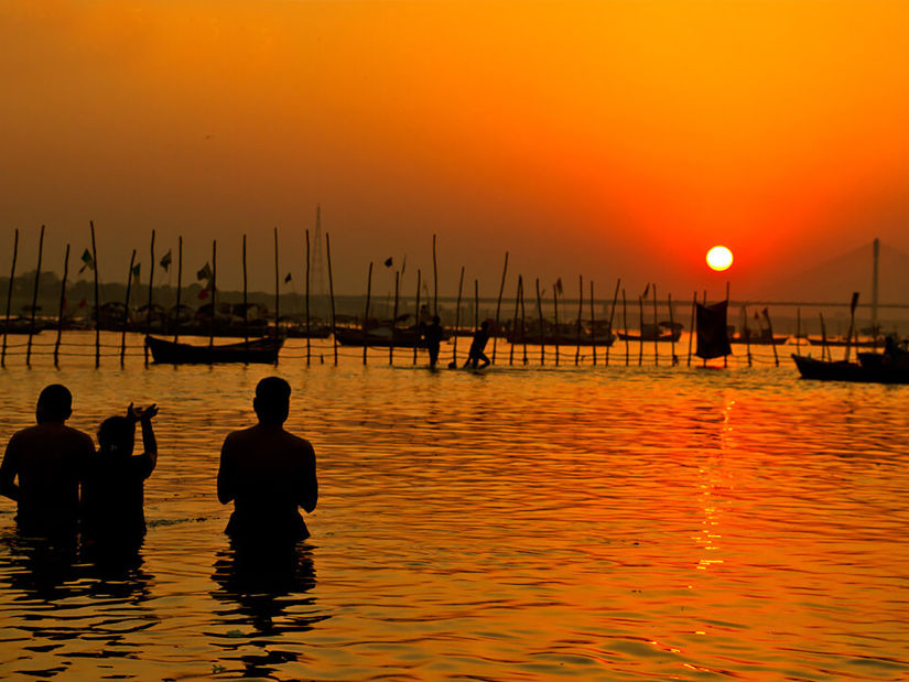 Hotel Polo Max, Allahabad - silhouette of people taking a dip in a river